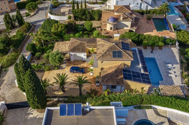 Aerial view of a premium second-line villa on the Benissa Costa with private pool, solar panels, garage, driveway and mature garden setting