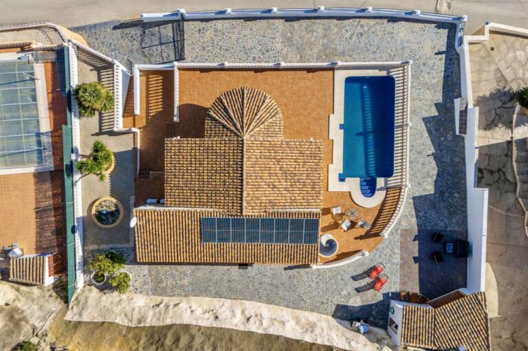 Aerial view of a villa in Calpe with private swimming pool, terrace areas, and surrounding residential setting.