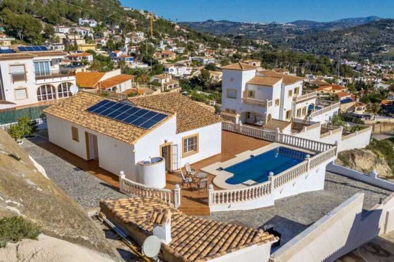 Aerial view of a villa in Calpe with private swimming pool, terraces, and sea views.