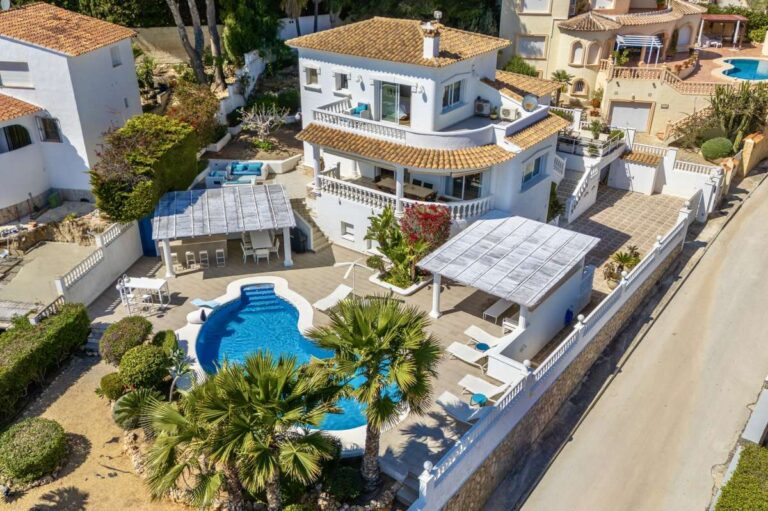 Aerial view of a villa in Calpe with private swimming pool, terraces, garage, and sea views.
