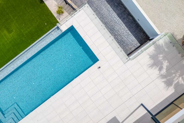 Aerial view of the private swimming pool and terrace at a modern second-line sea villa in La Calalga, Calpe