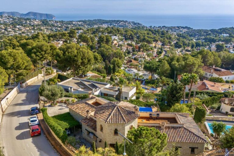 Aerial views from a finca-style villa in Benissa Costa showing surrounding homes, Mediterranean greenery, sea views and coastal landscape