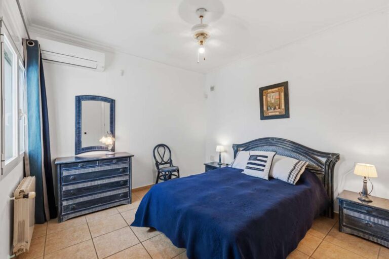 Alt text: Bedroom with fitted storage and natural light inside a villa in Calpe.