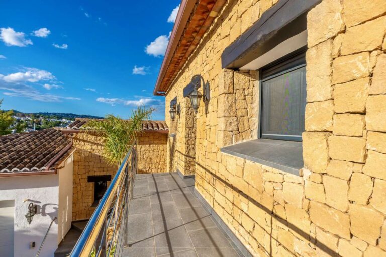 Balcony at a premium coastal villa on the Benissa Costa with stone exterior, railing, roof terrace views and Mediterranean surroundings