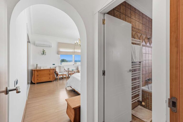 Bathroom entrance with bath and fitted vanity inside a villa in Calpe.