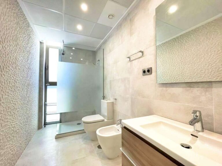 Bathroom inside a modern luxury villa in La Calalga, Calpe with walk-in shower, double vanity, toilet, bidet and bright tiled finish