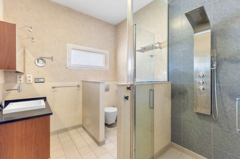 Bathroom inside a private villa in Calpe with walk-in shower, vanity unit, toilet and natural light