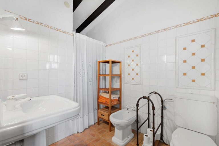 Bathroom inside a traditional Spanish finca near Moraira with bath, toilet, bidet, tiled walls and rustic Mediterranean details