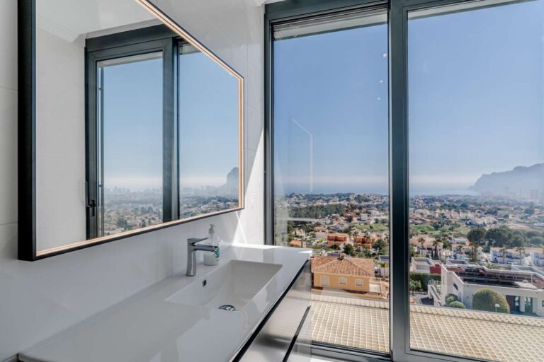 Bathroom vanity with large window and panoramic views inside a luxury villa in Gran Sol, Calpe.