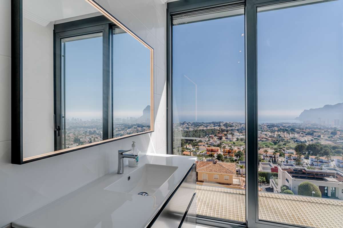 Bathroom vanity with large window and panoramic views inside a luxury villa in Gran Sol, Calpe.