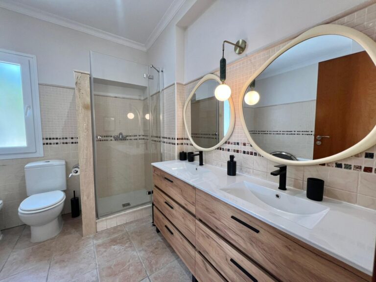 Bathroom with double sink at modern three-level villa in Moraira