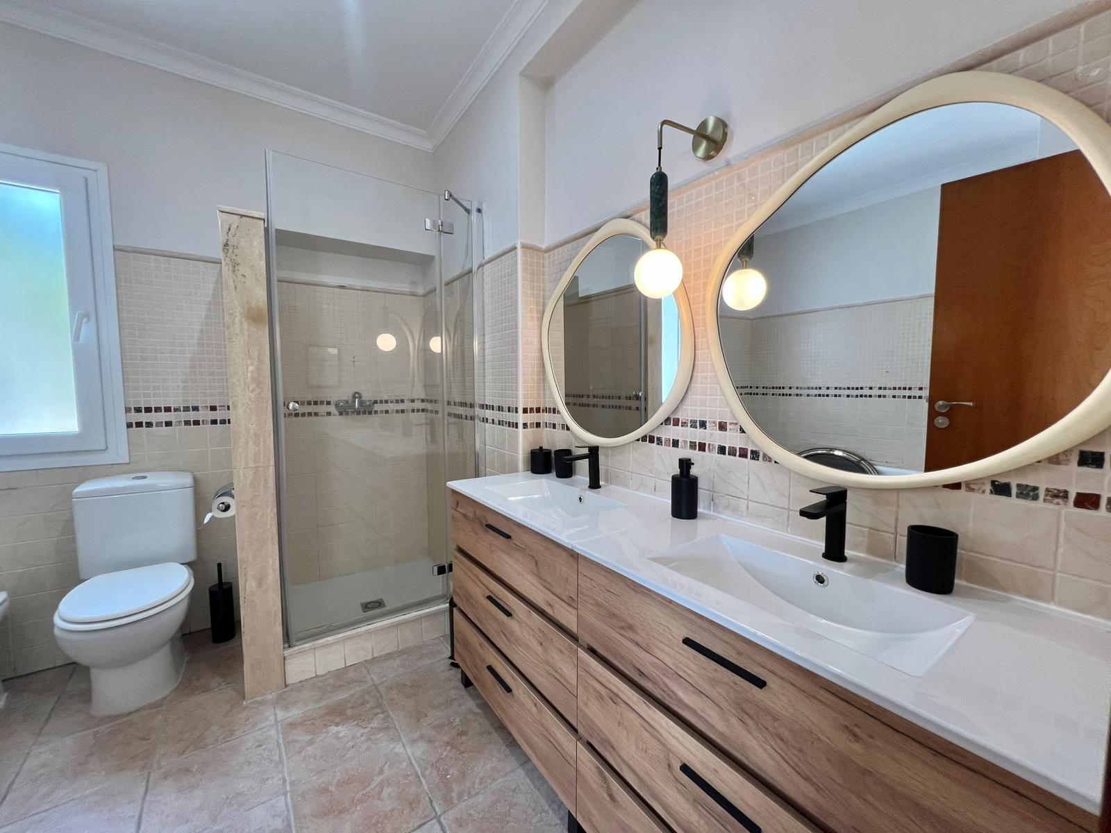 Bathroom with double sink at modern three-level villa in Moraira