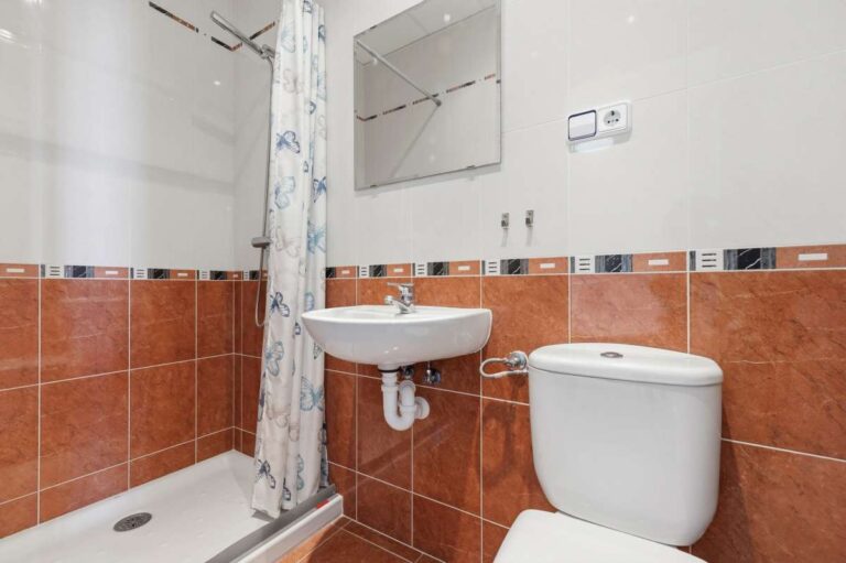 Bathroom with shower, sink, and toilet inside a villa in Calpe.