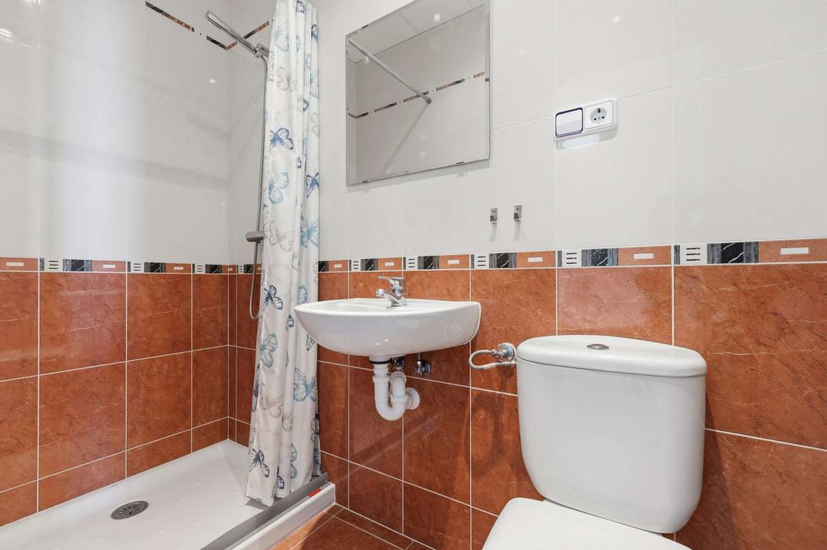 Bathroom with shower, sink, and toilet inside a villa in Calpe.