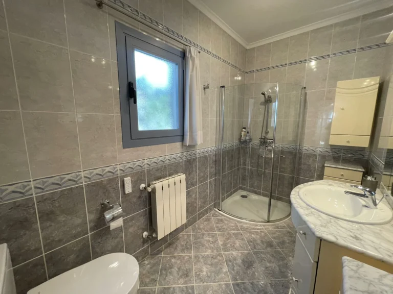 Bathroom with shower, vanity, and radiator inside a villa in Calpe.