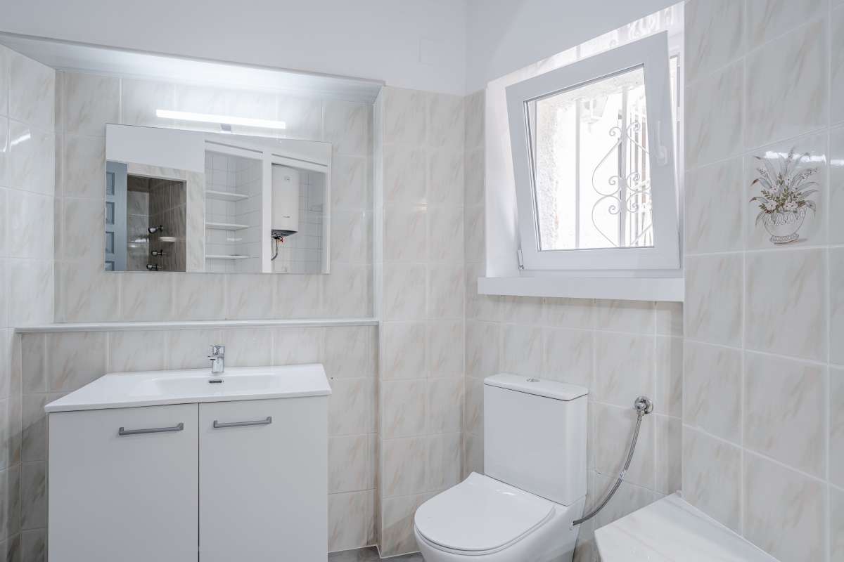 Bathroom with vanity, toilet and natural light inside an independent apartment at a Mediterranean villa in Maryvilla, Calpe.