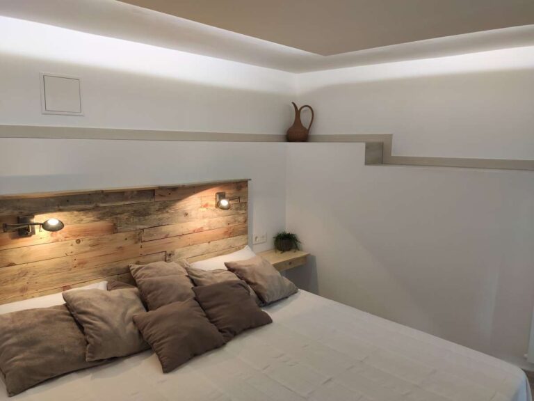 Bedroom detail with modern lighting and neutral finishes inside a refurbished villa in Canuta, Calpe.