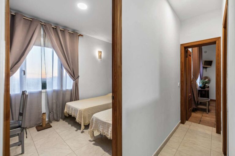 Bedroom hallway inside an independent living area of a panoramic sea view villa in Benissa with twin bedroom access and bright interior finish
