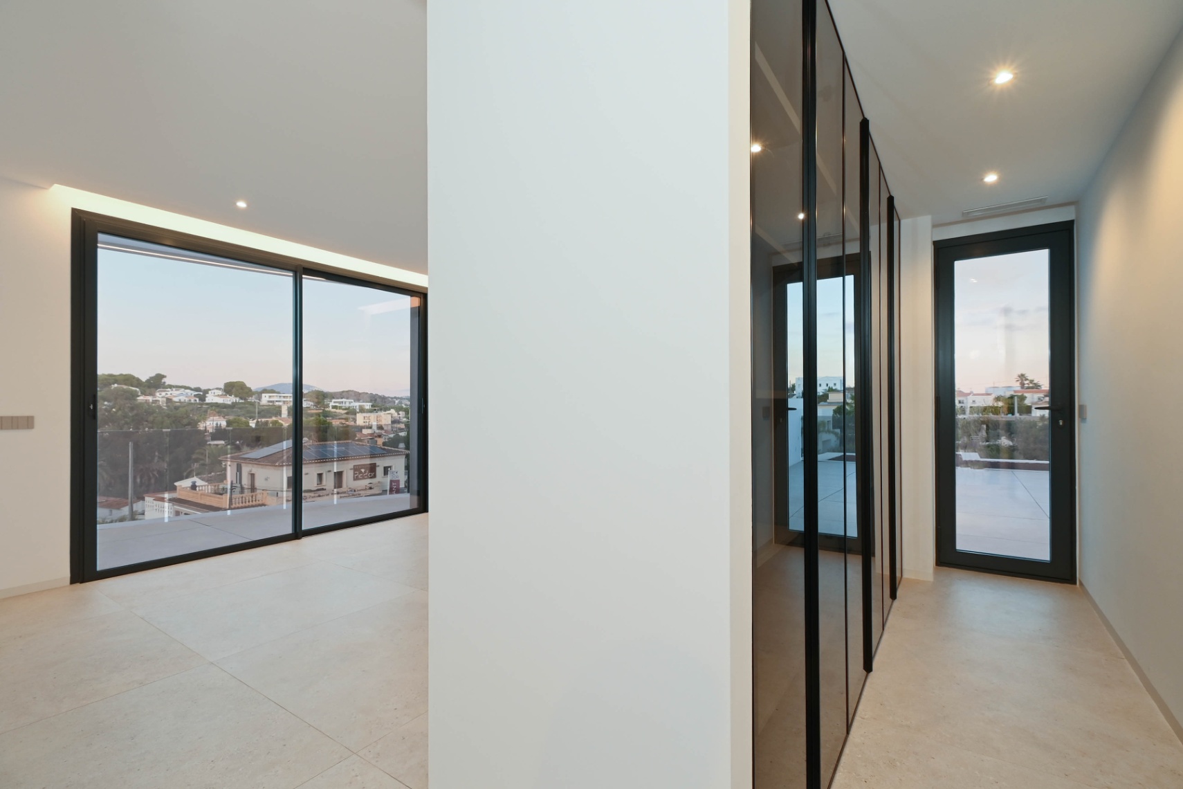 Bedroom hallway with large windows at luxury villa near La Fustera Beach