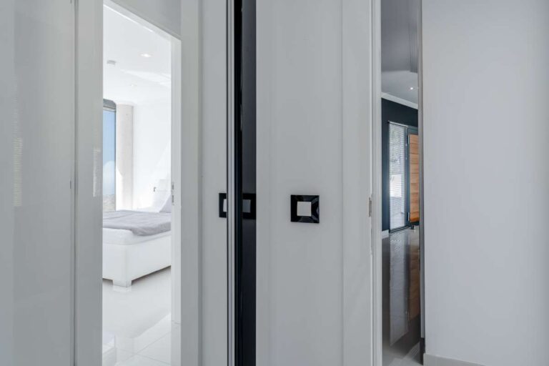 Bedroom hallway with white contemporary finishes inside a luxury villa with panoramic sea views in Gran Sol, Calpe.