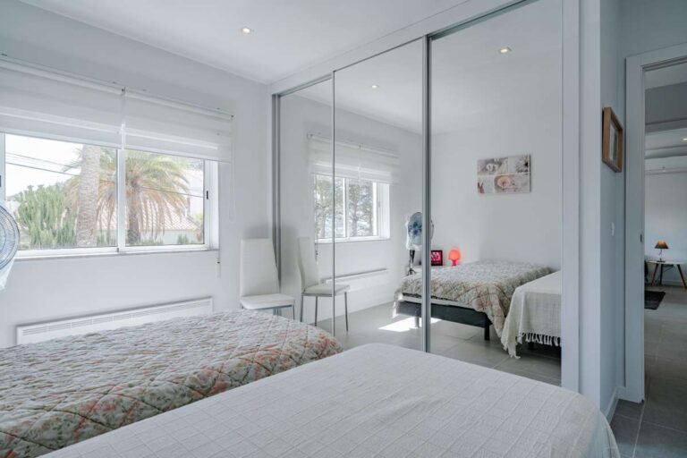 Bedroom inside a modern Calpe villa with fitted wardrobes, large window and natural light
