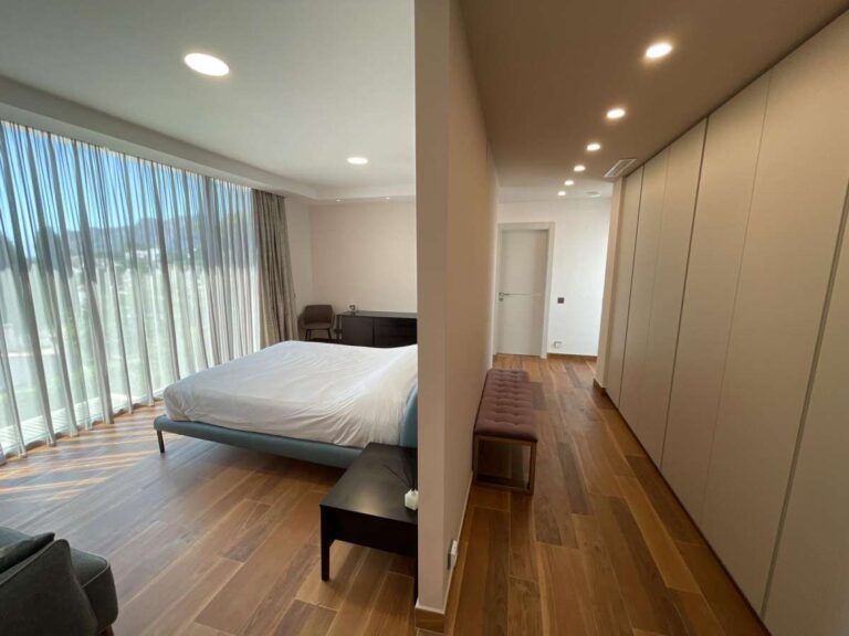 Bedroom inside a modern luxury villa in La Calalga, Calpe with fitted wardrobes, wooden flooring and large windows