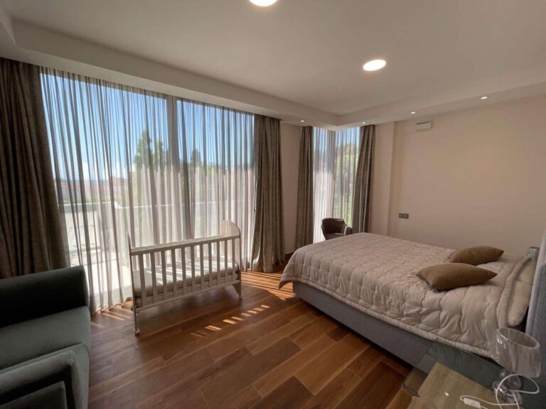 Bedroom inside a modern luxury villa in La Calalga, Calpe with wooden flooring, large windows, terrace access and natural light