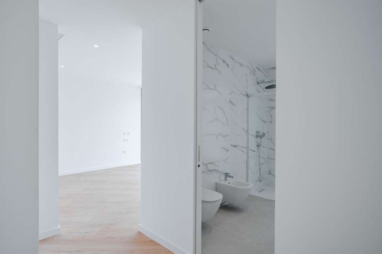 Bedroom inside a modern second-line sea villa in La Calalga, Calpe with access to an en-suite bathroom and bright contemporary finish