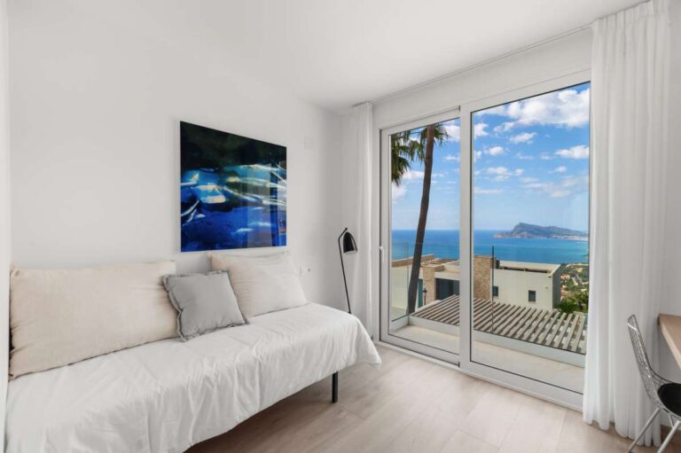 Bedroom inside a modern villa in Altea Hills with terrace access, Mediterranean Sea views, mountain views and bright neutral interior