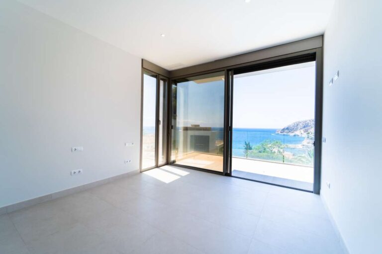 Schlafzimmer in einer neu gebauten Luxusvilla in der Nähe des Yachthafens Puerto Blanco in Calpe mit großen Fenstern, Meerblick, Bergblick und Zugang zur Terrasse