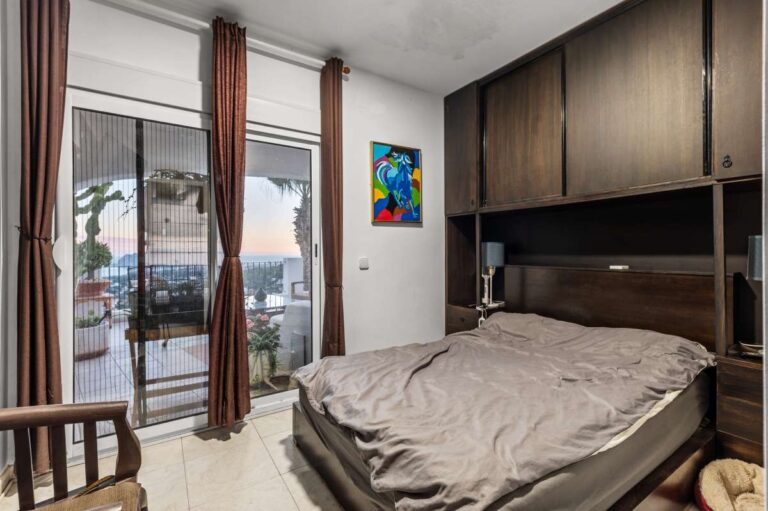 Bedroom inside a panoramic sea view villa in Benissa with terrace access, fitted storage and views towards Calpe and the Peñón de Ifach
