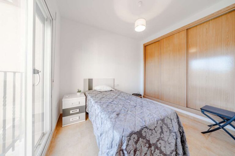Bedroom inside a semi-detached house in Calpe with built-in wardrobes, natural light and access to a private terrace