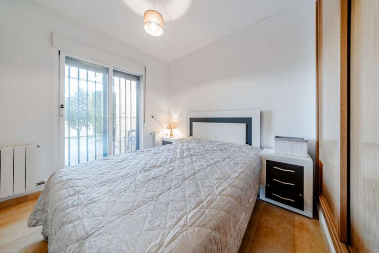 Bedroom inside a semi-detached house in Calpe with built-in wardrobes, natural light and access to the terrace