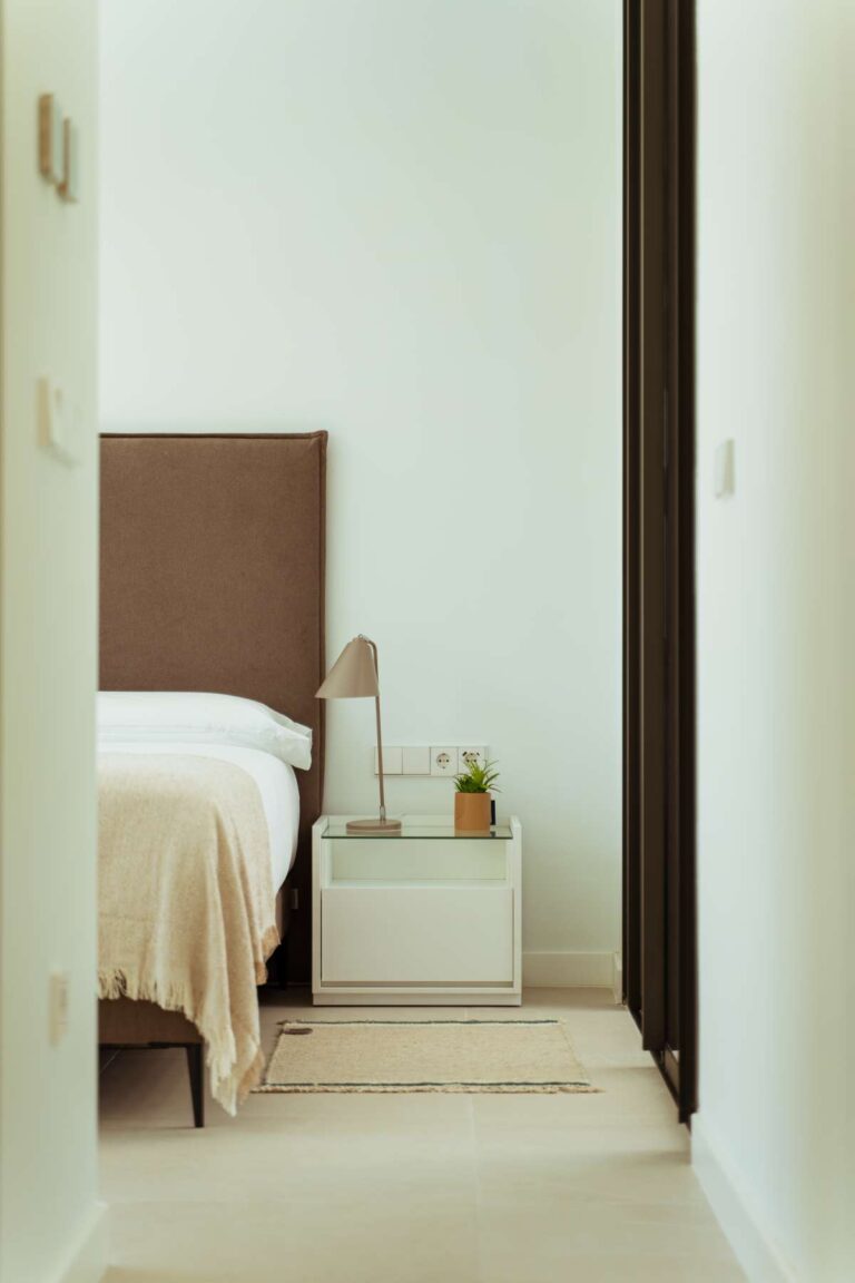 Bedroom interior inside a new-build luxury villa in Moraira with modern furnishings, soft neutral finish and hallway access