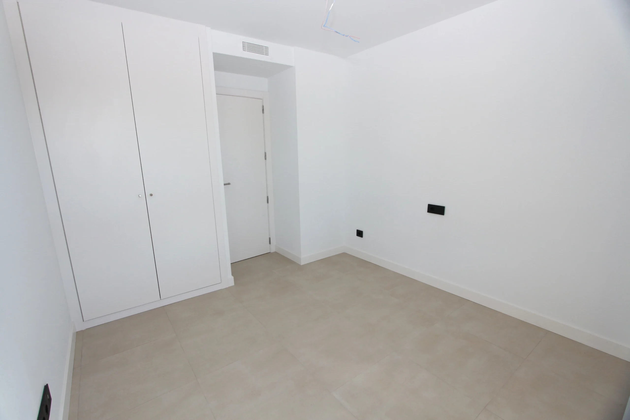 Bedroom with built-in wardrobes inside luxury penthouse in Calpe`