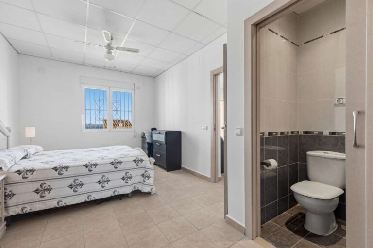 Bedroom with direct en-suite bathroom access inside a villa in Calpe.