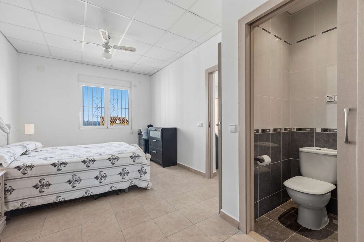 Bedroom with direct en-suite bathroom access inside a villa in Calpe.