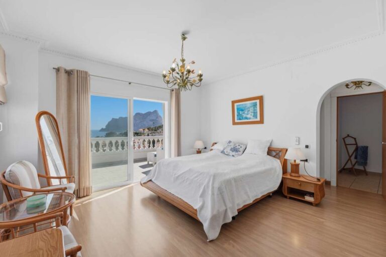 Bedroom with direct terrace access and natural light inside a villa in Calpe.