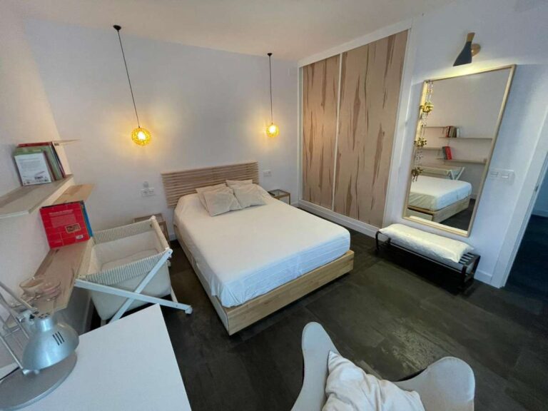 Bedroom with fitted wardrobe, mirror and modern lighting inside a refurbished villa in Canuta, Calpe.
