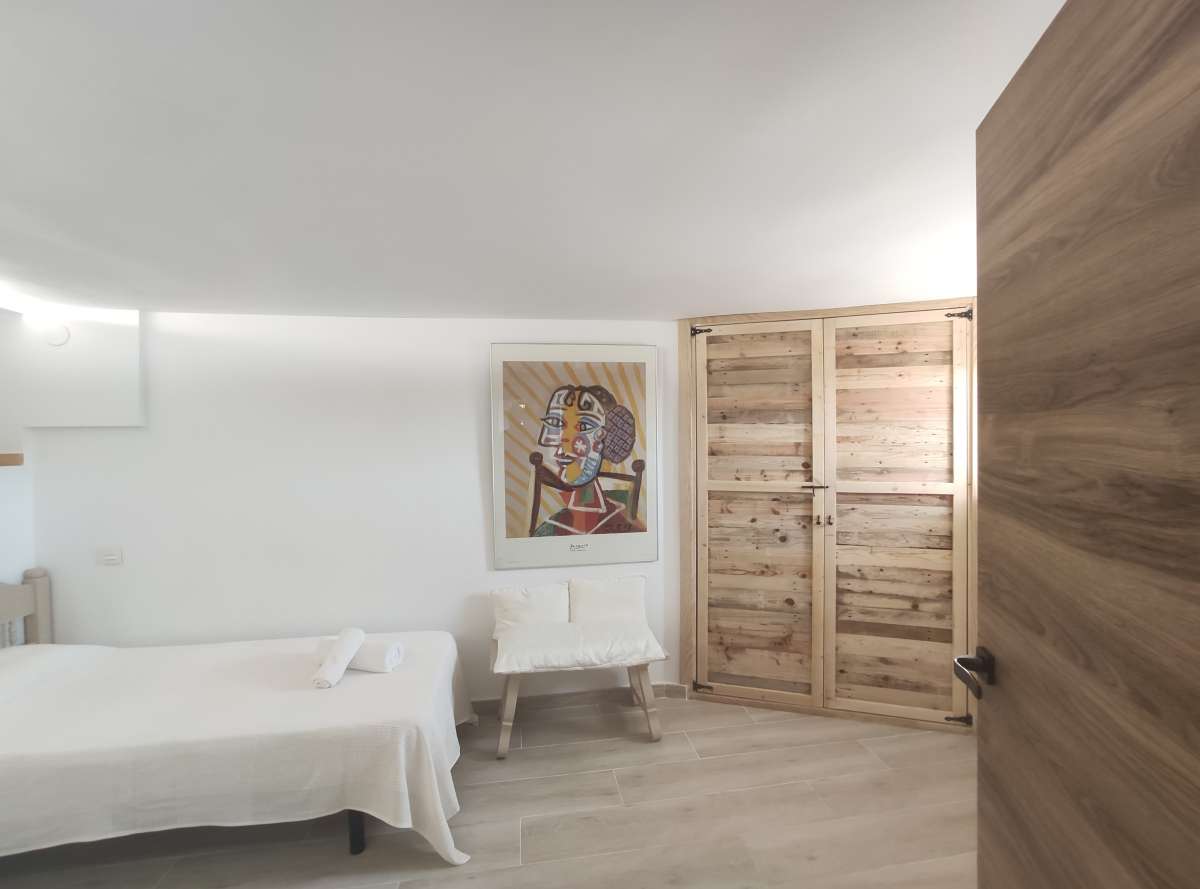 Bedroom with fitted wardrobes and light interior inside a refurbished villa with three independent apartments in Canuta, Calpe.