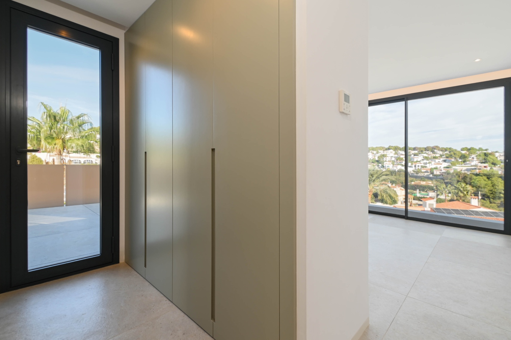 Bedroom with fitted wardrobes and terrace access at luxury villa in Benissa