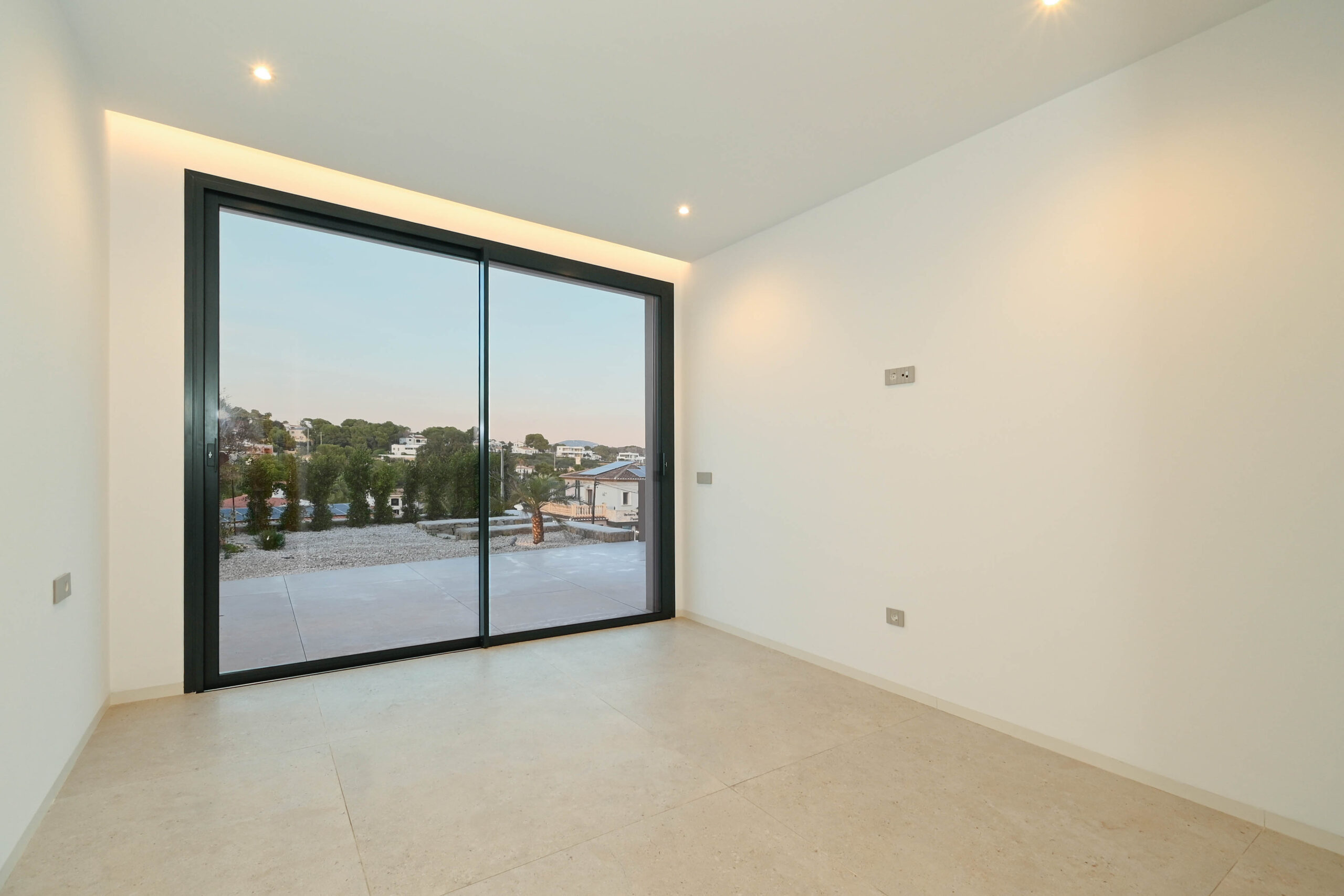 Bedroom with large terrace doors at newly built luxury villa in Benissa