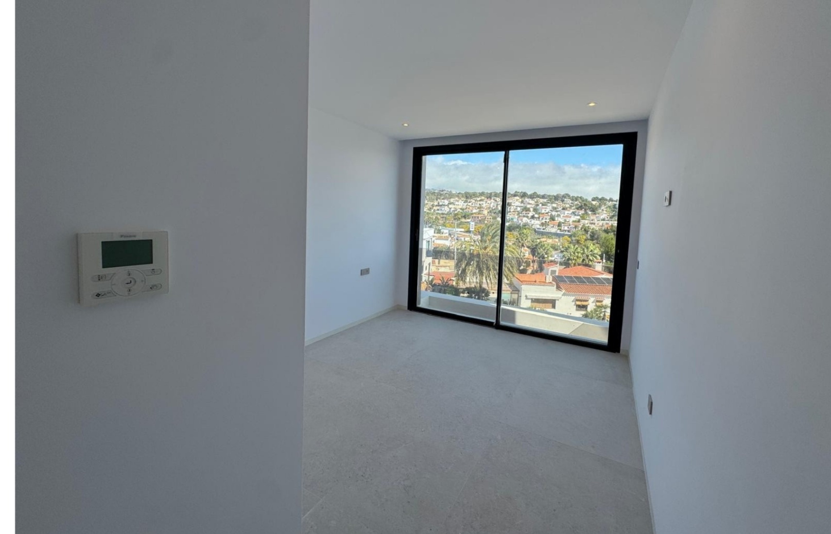 Bedroom with large window at luxury villa near La Fustera Beach