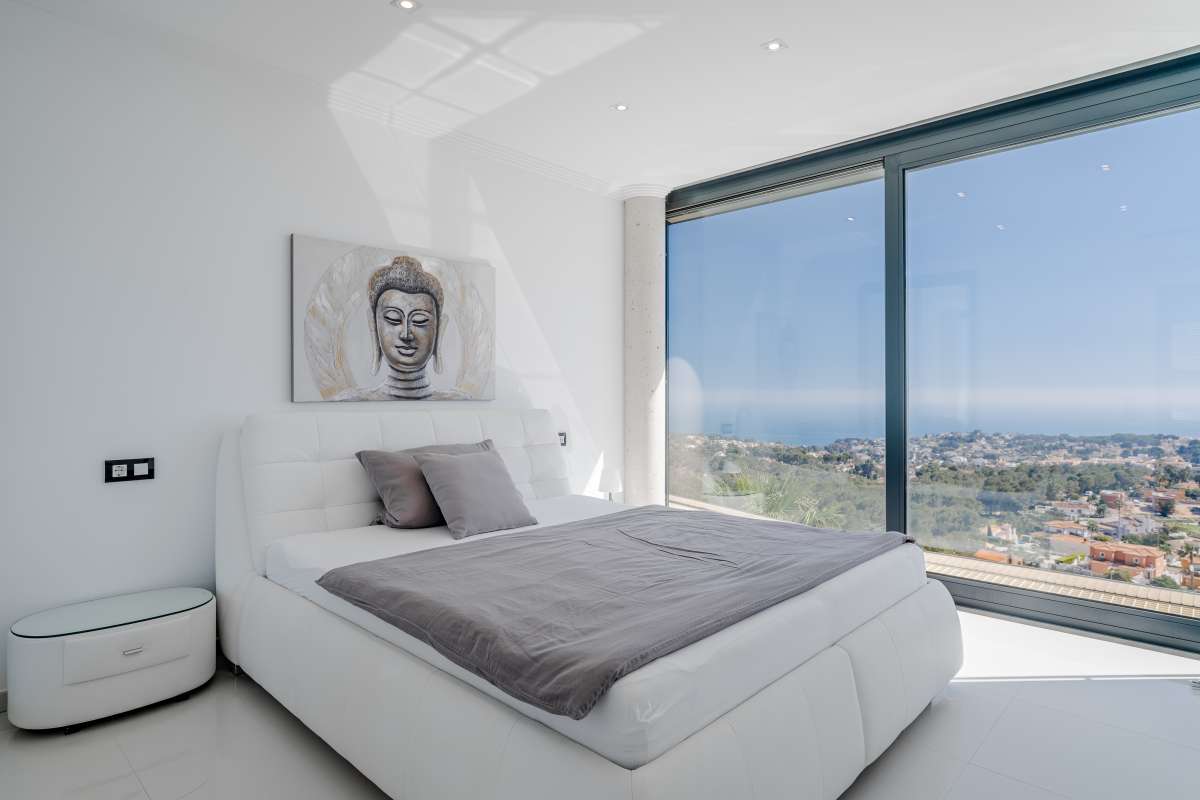 Bedroom with large window, contemporary finishes and panoramic sea views inside a luxury villa in Gran Sol, Calpe.