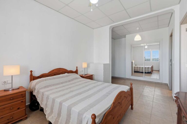 Bedroom with natural light and en-suite access inside a villa in Calpe.