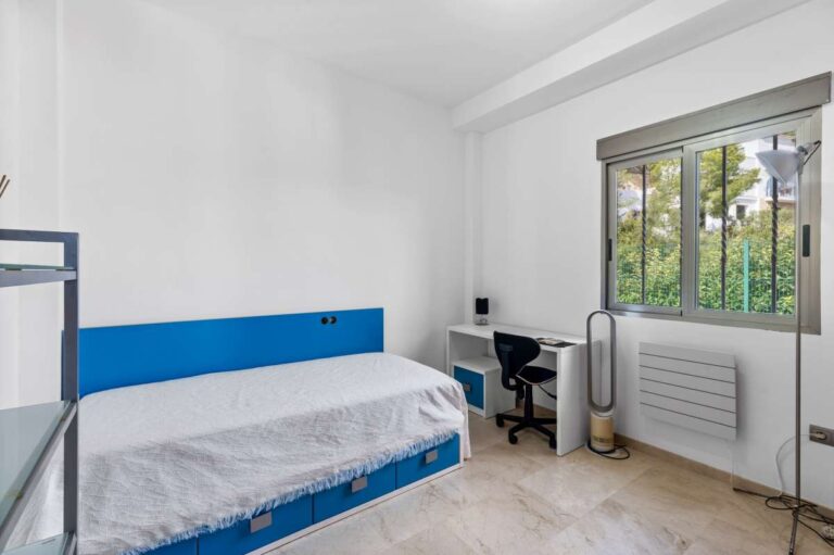 Bedroom with natural light and fitted radiator inside a modern spacious villa with panoramic sea views in Calpe.