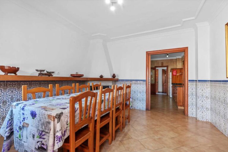 Bedroom with wooden furniture and tiled flooring inside a spacious villa in Calpe.