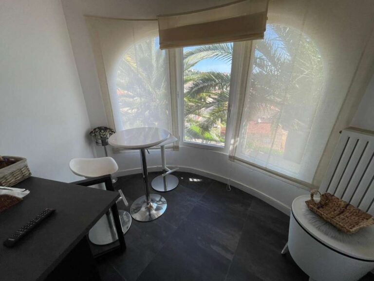 Breakfast area with large windows and sea views inside a refurbished villa in Canuta, Calpe.