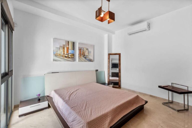 Bright bedroom with air conditioning and natural light inside a modern spacious villa with panoramic sea views in Calpe.