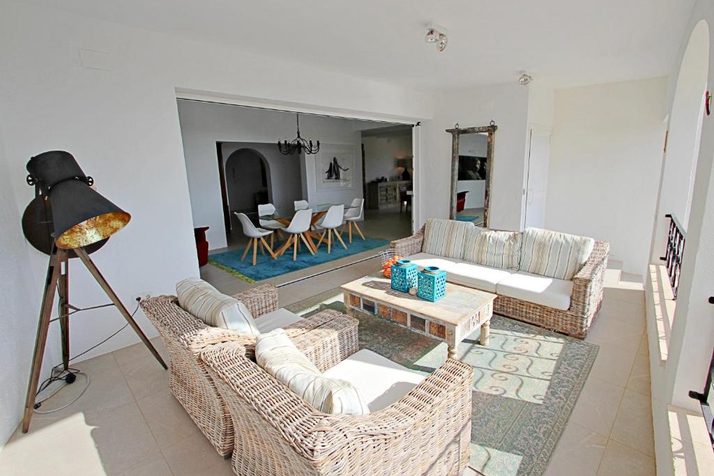 Bright covered terrace with lounge and dining area at Moraira villa